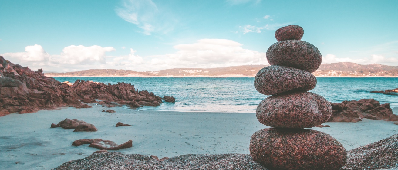 Rocks balancing near a shoreline