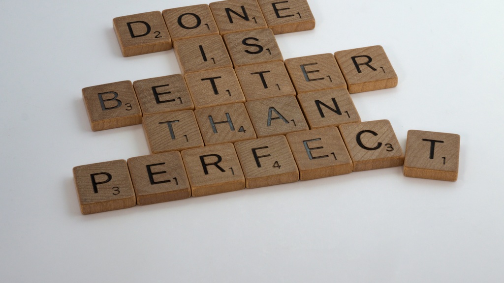 scrabble letters that read "done is better than perfect"