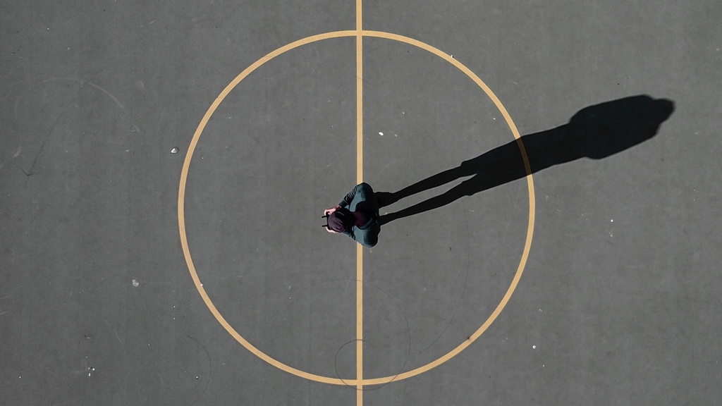 A person standing in the center of a basketball court